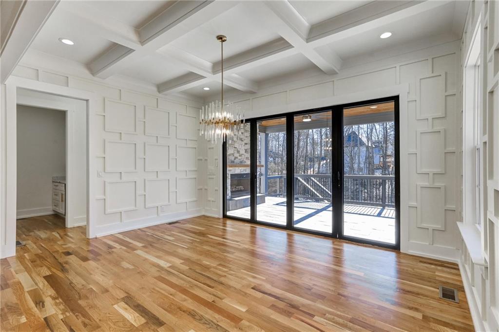 6113 Deepwater Cove Gainesville, GA 30506 - Photo 20 of 82 a view of an empty room with wooden floor and a window