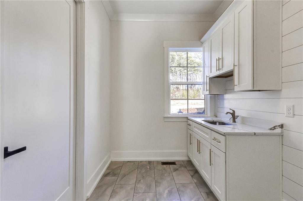 6113 Deepwater Cove Gainesville, GA 30506 - Photo 33 of 82 a kitchen with a sink a window and cabinets