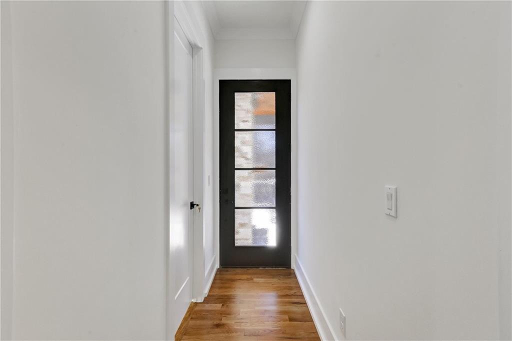 6113 Deepwater Cove Gainesville, GA 30506 - Photo 35 of 82 a view of a hallway with wooden floor and a bathroom