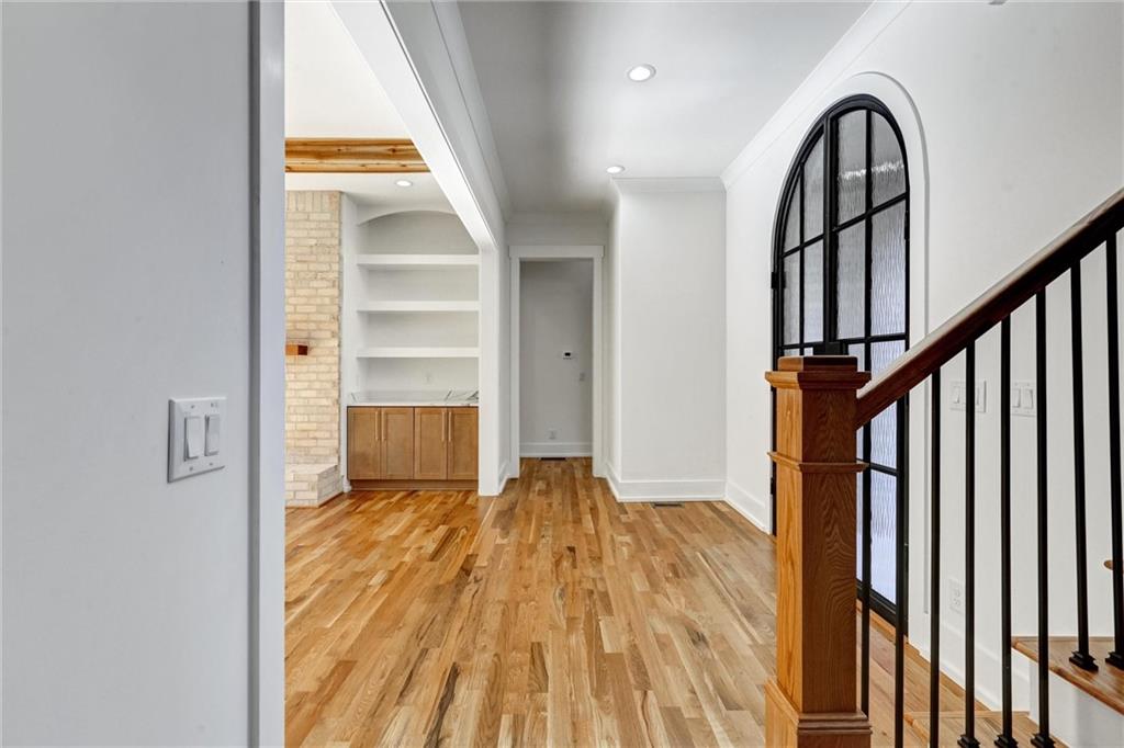 6113 Deepwater Cove Gainesville, GA 30506 - Photo 37 of 82 a view of a hallway with wooden floor and staircase