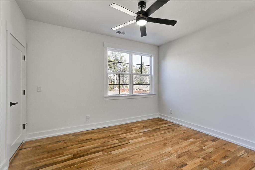 6113 Deepwater Cove Gainesville, GA 30506 - Photo 40 of 82 wooden floor in an empty room with a window