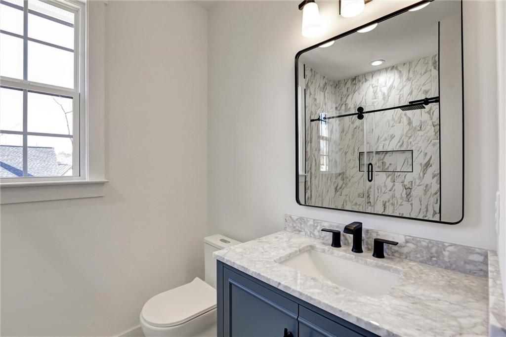 6113 Deepwater Cove Gainesville, GA 30506 - Photo 42 of 82 a bathroom with a granite countertop sink toilet and mirror