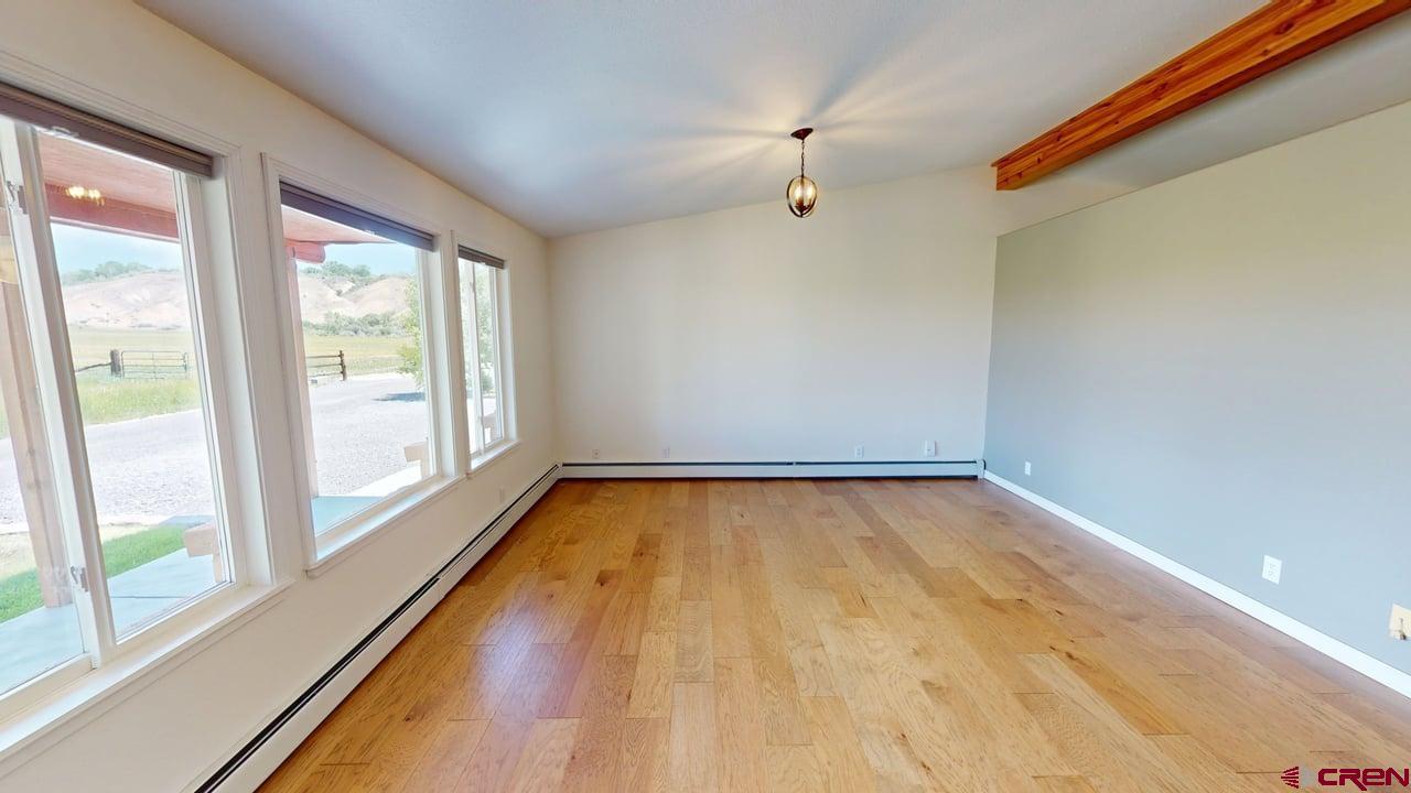 11694 Trap Club Road Austin, CO 81410 - Photo 11 of 45 a view of a room with wooden floor and window