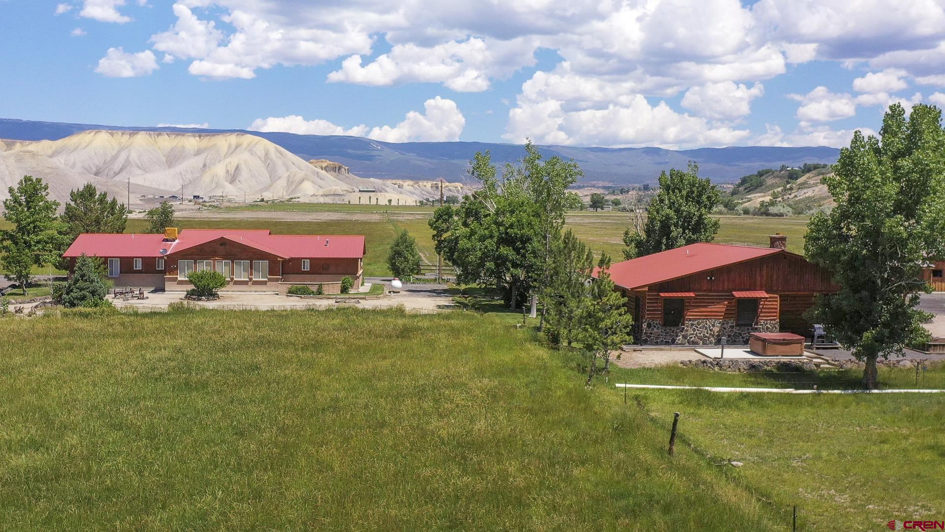 11694 Trap Club Road Austin, CO 81410 - Photo 14 of 45 a view of a swimming pool with an outdoor seating and a yard