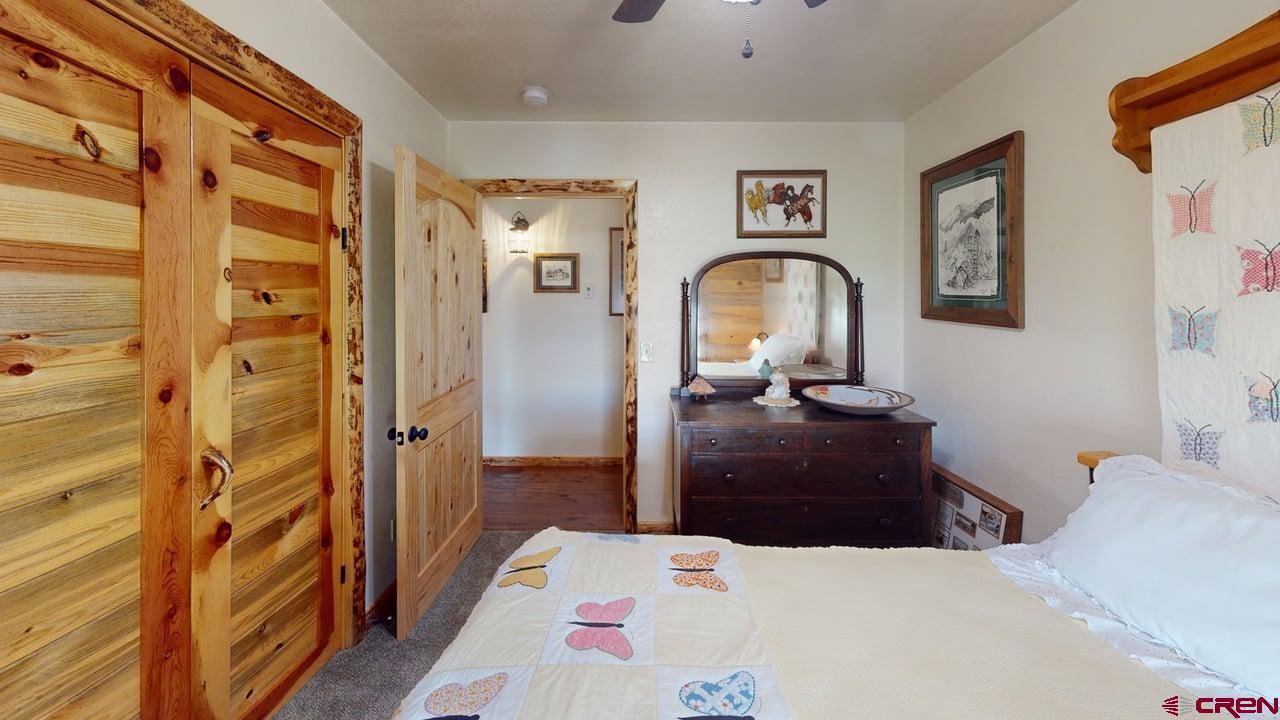 11694 Trap Club Road Austin, CO 81410 - Photo 18 of 45 a bedroom with a bed and a mirror
