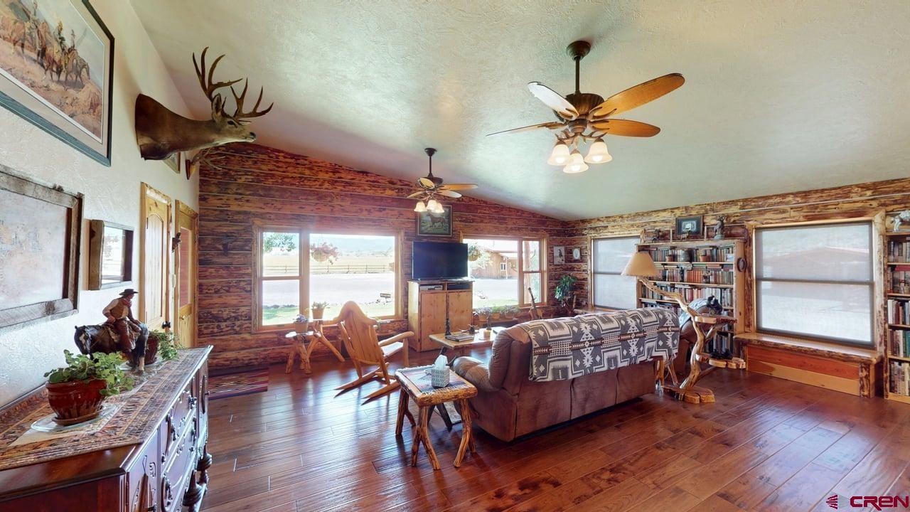 11694 Trap Club Road Austin, CO 81410 - Photo 20 of 45 a bedroom with furniture window and wooden floor