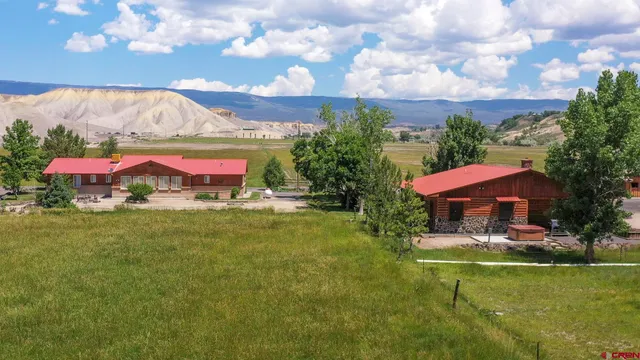 a view of a swimming pool with an outdoor seating and a yard