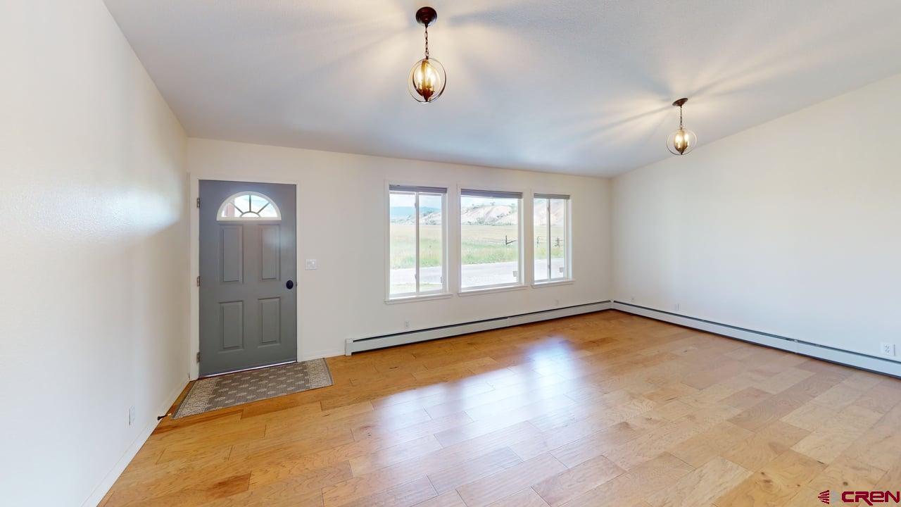 11694 Trap Club Road Austin, CO 81410 - Photo 23 of 45 wooden floor in an empty room with a window