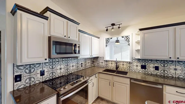 a view of a big room with wooden floor and a ceiling fan