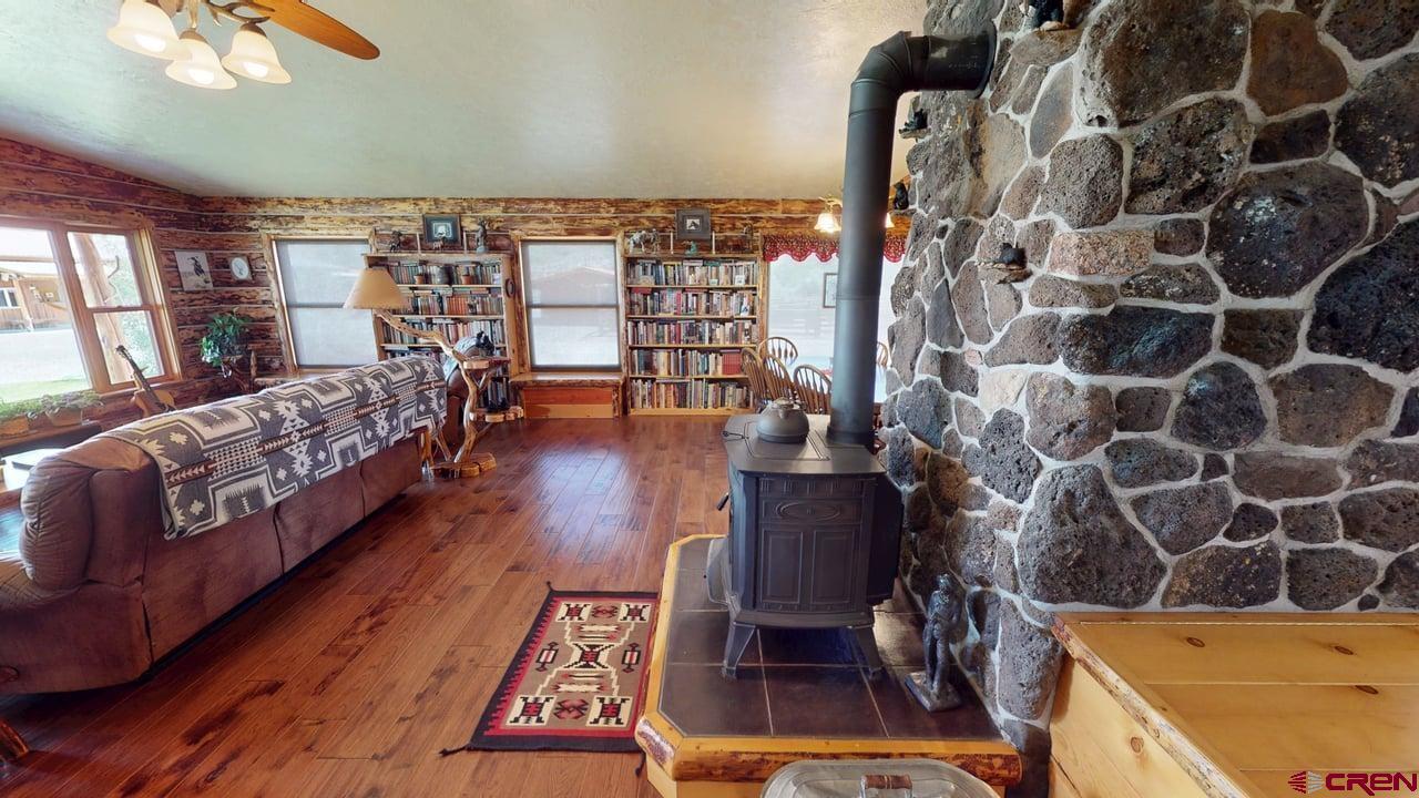 11694 Trap Club Road Austin, CO 81410 - Photo 3 of 45 a bedroom with a bed and wooden floor