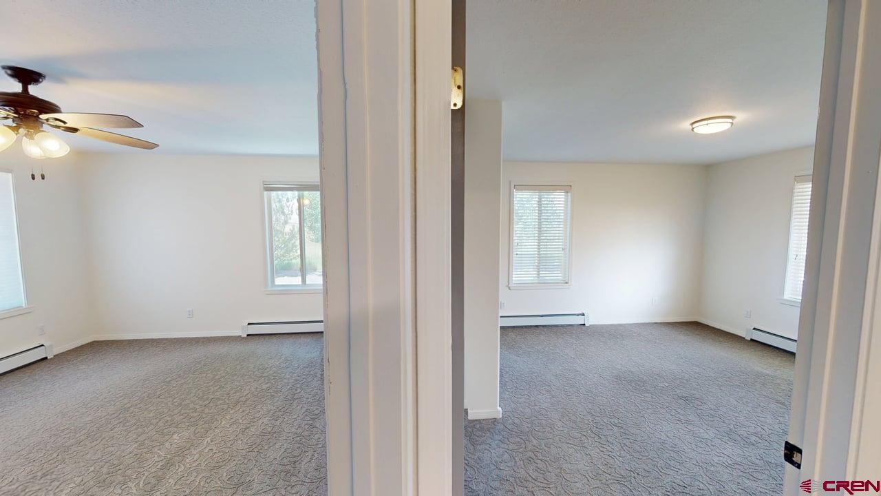 11694 Trap Club Road Austin, CO 81410 - Photo 32 of 45 an empty room with windows and closet