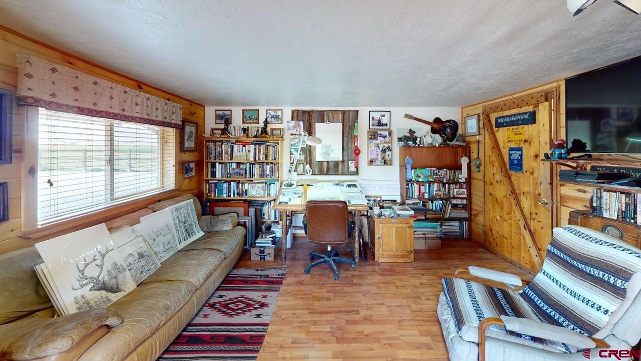 11694 Trap Club Road Austin, CO 81410 - Photo 33 of 45 a living room with furniture and a flat screen tv