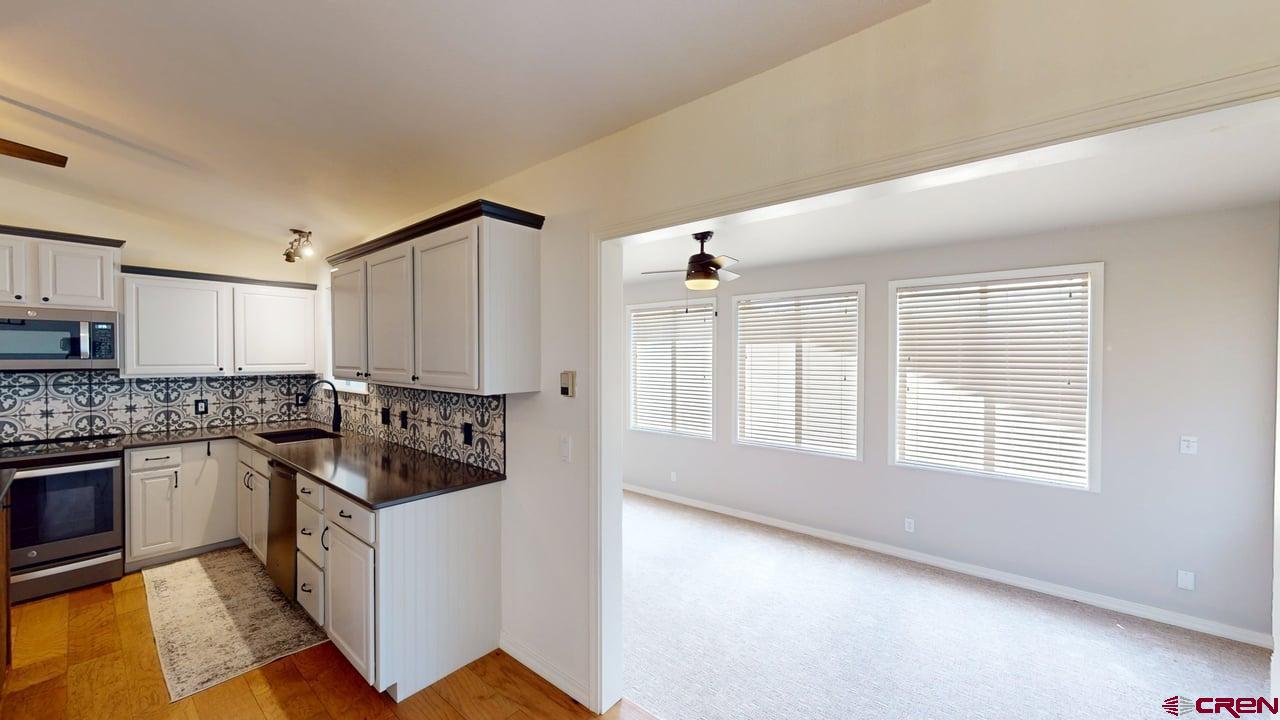 11694 Trap Club Road Austin, CO 81410 - Photo 33 of 45 a kitchen with stainless steel appliances granite countertop a stove a sink and a refrigerator