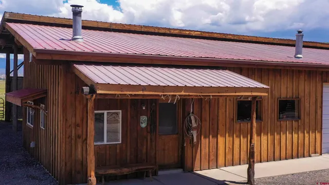 a living room with lots of furniture and a large window
