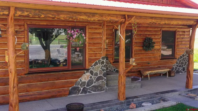 a view of a porch with a table and chairs