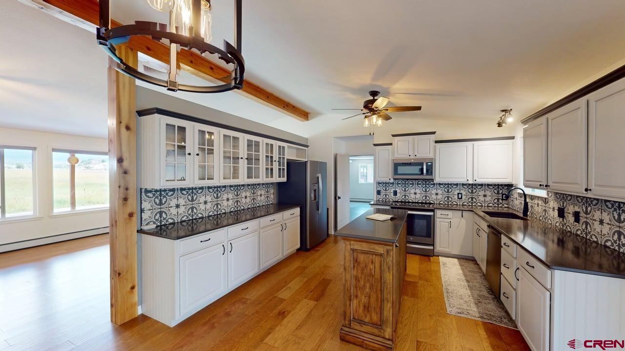 11694 Trap Club Road Austin, CO 81410 - Photo 9 of 45 a kitchen with stainless steel appliances granite countertop a stove oven and a refrigerator