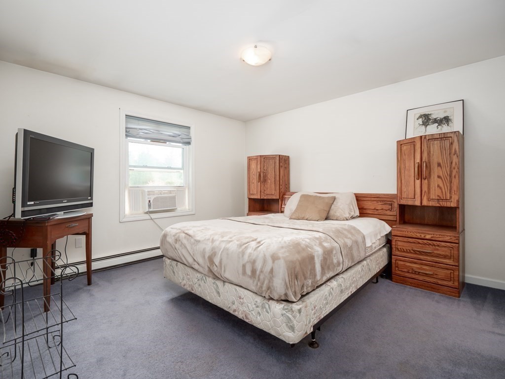 281 Brooks Station Road Princeton, MA 01541 - Photo 14 of 42 a bedroom with a bed and a flat screen tv