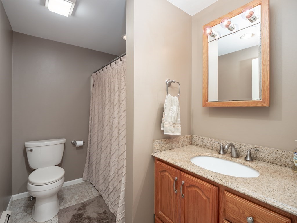 281 Brooks Station Road Princeton, MA 01541 - Photo 18 of 42 a bathroom with a granite countertop sink toilet and mirror