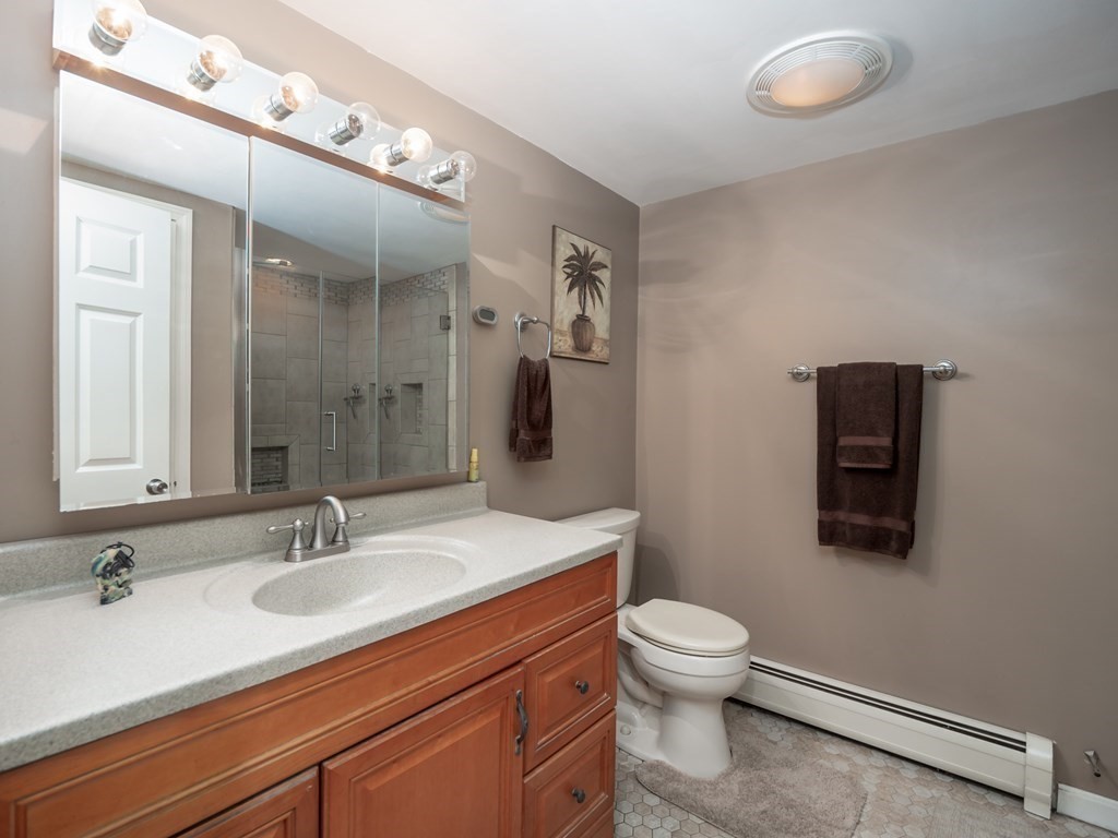 281 Brooks Station Road Princeton, MA 01541 - Photo 23 of 42 a bathroom with a sink a toilet and mirror