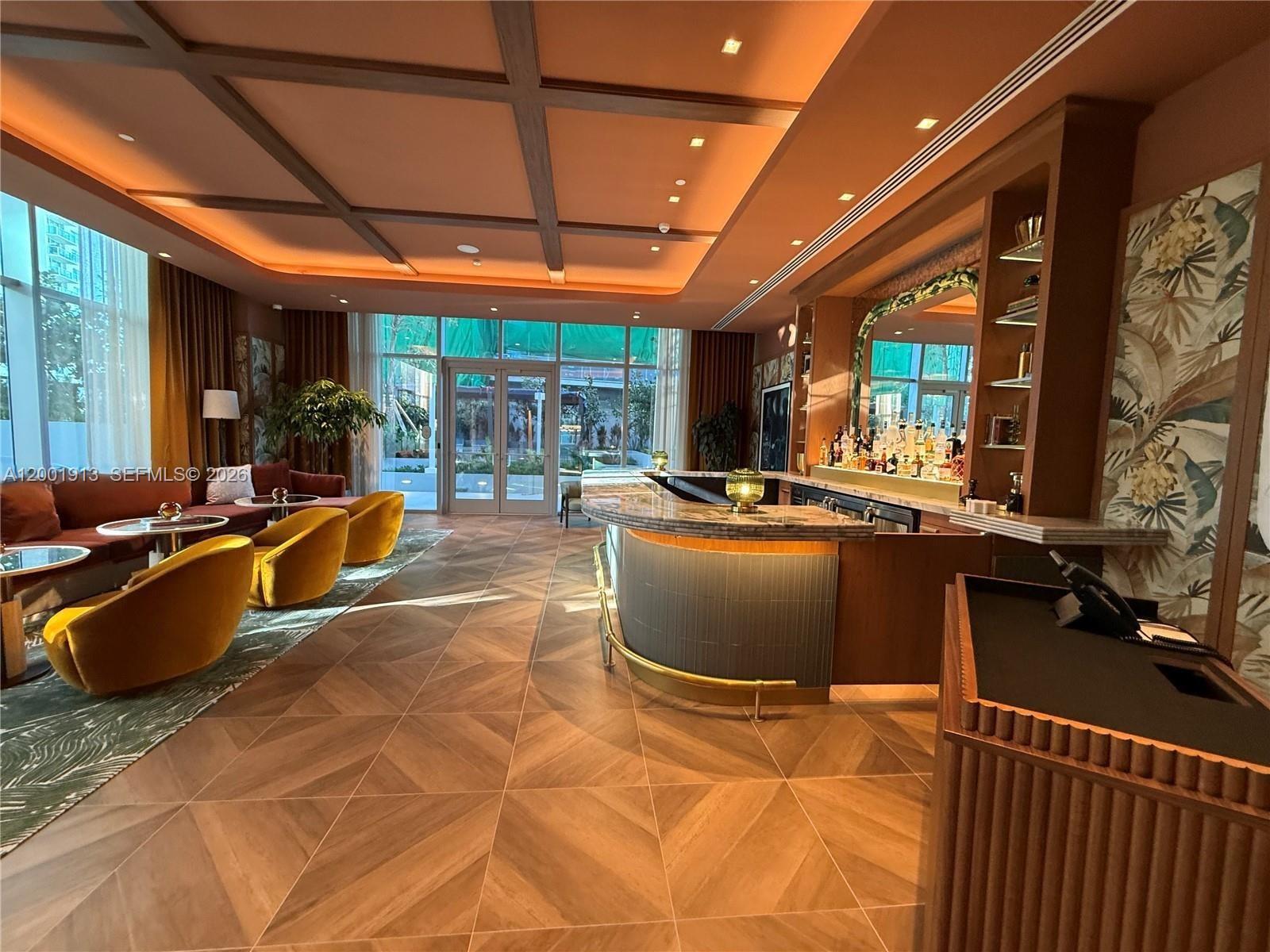 77 Southeast 5th Street, Unit 1007 Miami, FL 33131 - Photo 21 of 31 a room with furniture and flat screen tv