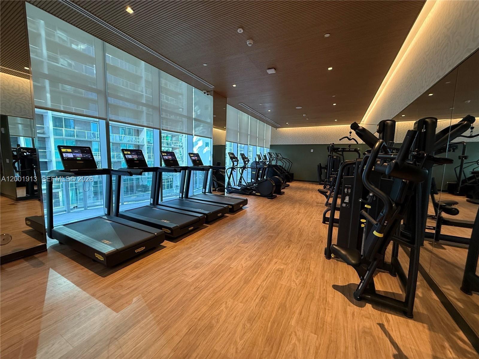 77 Southeast 5th Street, Unit 1007 Miami, FL 33131 - Photo 29 of 31 a view of a room with gym equipment