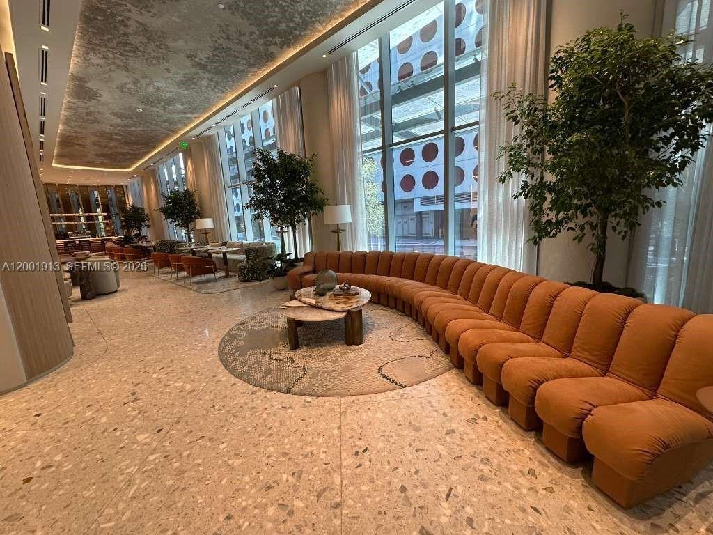 77 Southeast 5th Street, Unit 1007 Miami, FL 33131 - Photo 30 of 31 a view of a patio with couches and potted plants