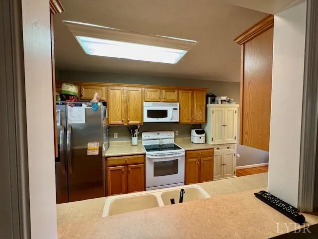 a kitchen with stainless steel appliances granite countertop a refrigerator and a stove top oven