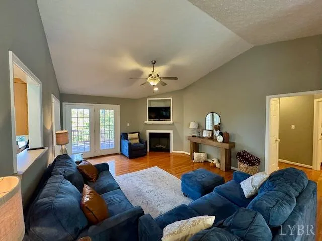 a living room with furniture fireplace and a large window