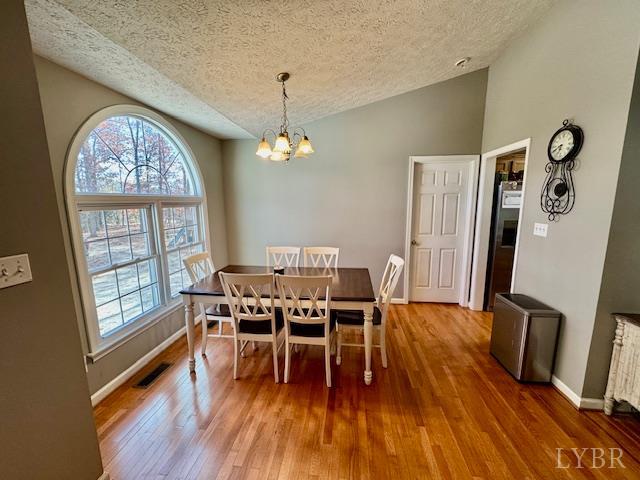 1351 Purdum Mill Road Appomattox, VA 24522 - Photo 9 of 28 a view of a dining room with furniture a chandelier and wooden floor
