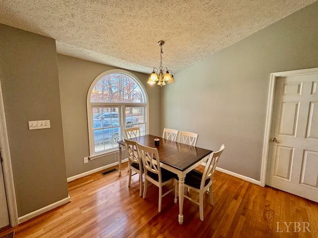 1351 Purdum Mill Road Appomattox, VA 24522 - Photo 10 of 28 a dining room with furniture a chandelier and wooden floor