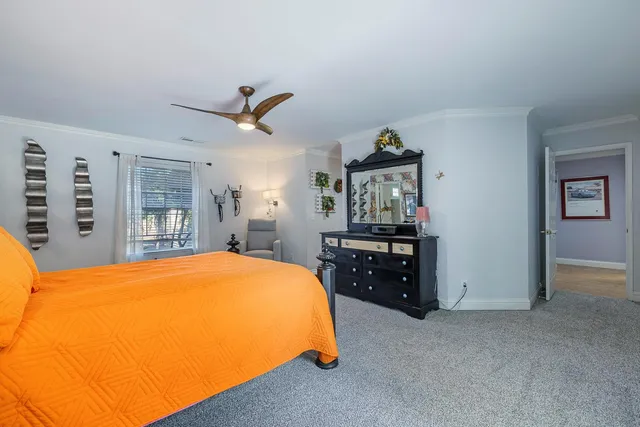 a bed room with a bed and a chair