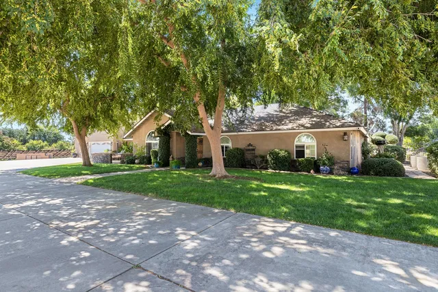 a front view of house with yard and green space