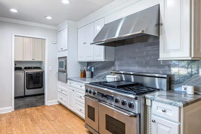 a dining room with furniture and wooden floor