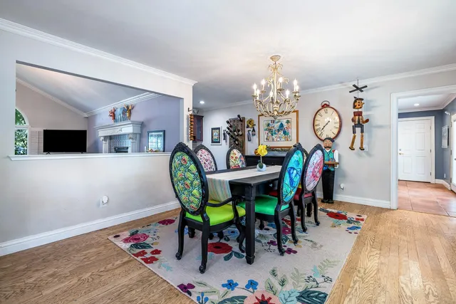 a view of a dining room with furniture and chandelier