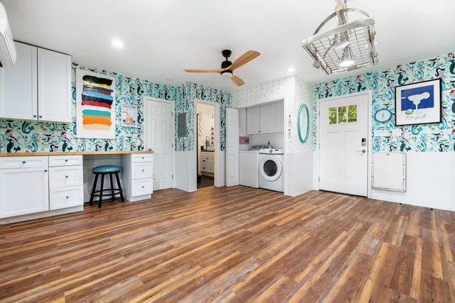 a kitchen with stainless steel appliances kitchen island granite countertop a stove cabinets and wooden floor