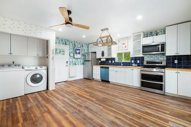 a kitchen with stainless steel appliances granite countertop a refrigerator stove and oven