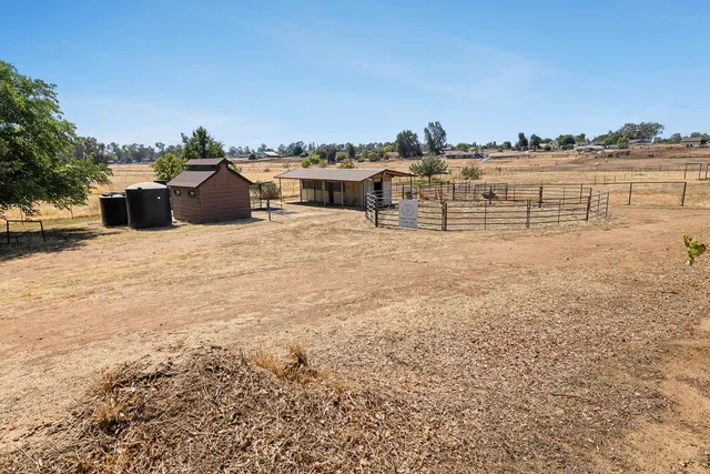 an aerial view of residential house with outdoor space and swimming pool