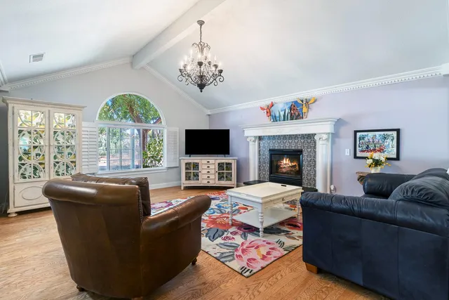 a living room with furniture large window and flat screen tv