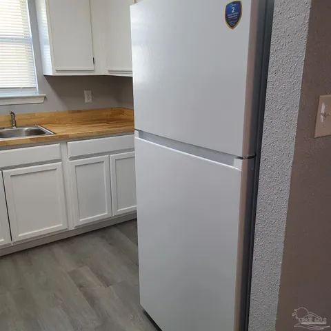 a view of cabinets and wooden floor