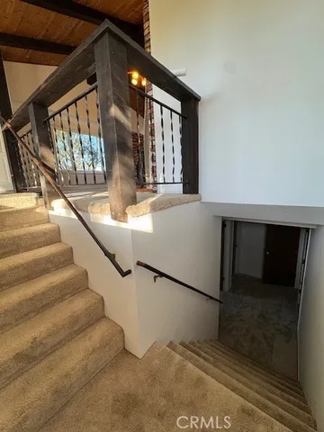 a living room with furniture and a staircase