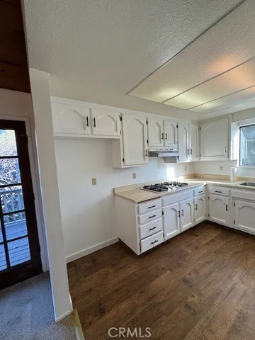 a kitchen with cabinets a sink and a stove top oven