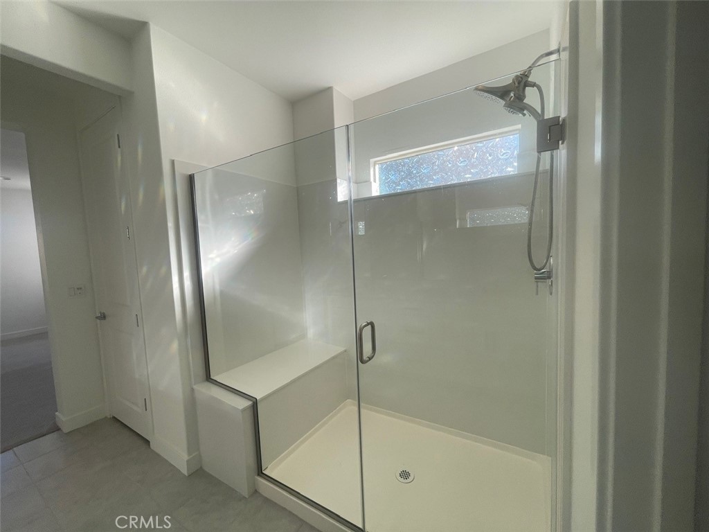 170 Episode Irvine, CA 92618 - Photo 20 of 63 a bathroom with a glass shower door