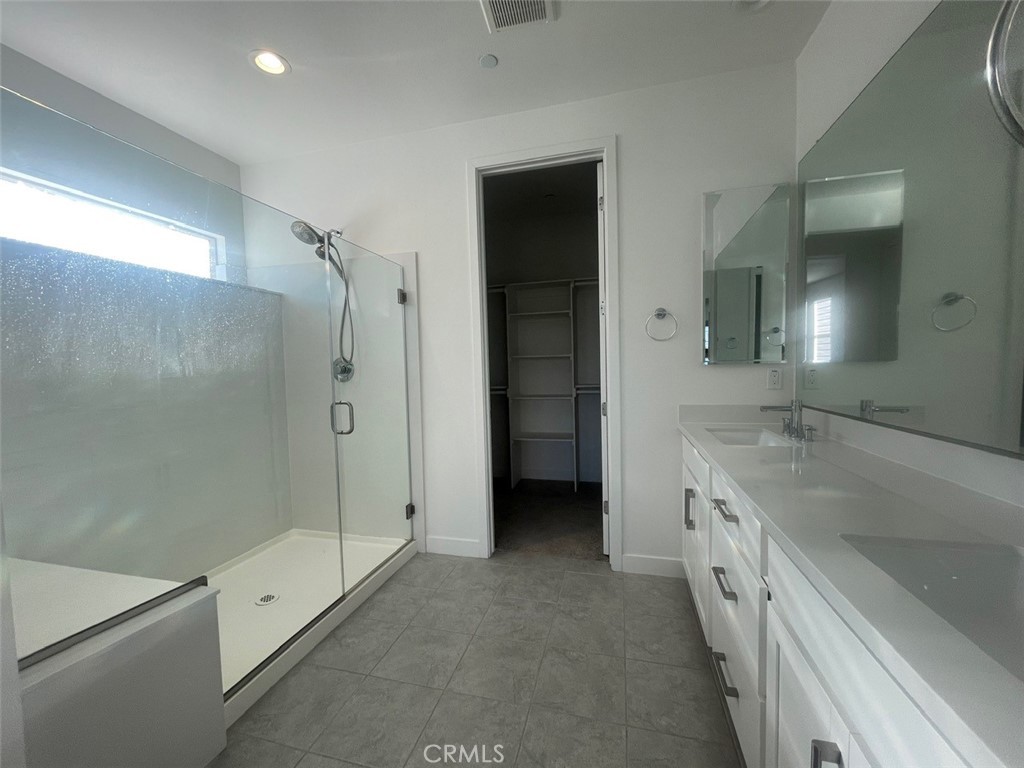 170 Episode Irvine, CA 92618 - Photo 22 of 63 a spacious bathroom with a granite countertop sink a toilet and shower