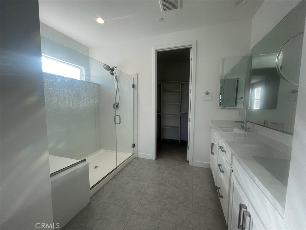 170 Episode Irvine, CA 92618 - Photo 23 of 63 a bathroom with a granite countertop sink a shower and a mirror
