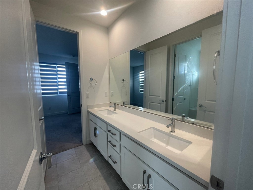 170 Episode Irvine, CA 92618 - Photo 32 of 63 a bathroom with a double vanity sink and mirror