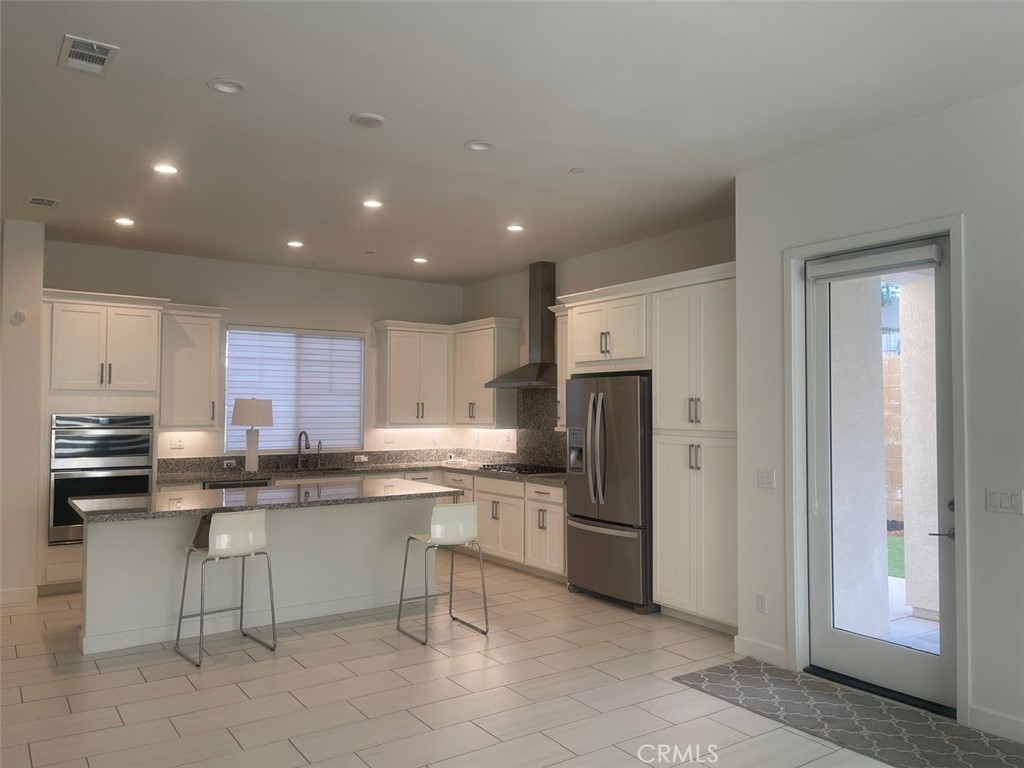 170 Episode Irvine, CA 92618 - Photo 5 of 63 a kitchen with stainless steel appliances granite countertop a refrigerator and a stove top oven