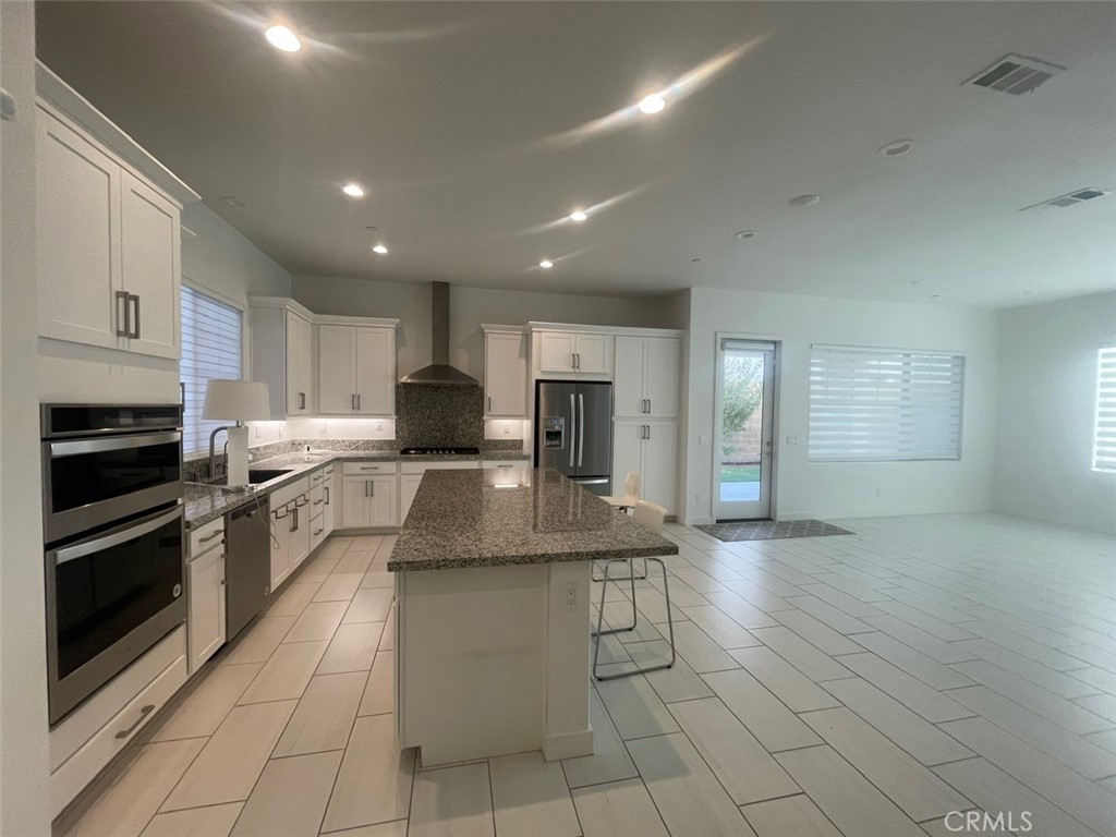 170 Episode Irvine, CA 92618 - Photo 10 of 63 a kitchen with stainless steel appliances granite countertop a stove a sink and a refrigerator