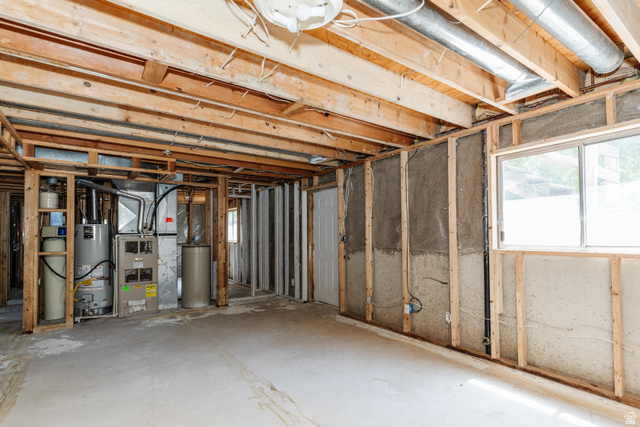 342 East 600 North Logan, UT 84321 - Photo 11 of 23 Unfinished basement space featuring exposed wood framing, a concrete floor, and visible utility systems