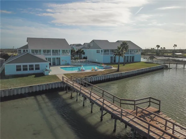 a balcony with chairs and table with wooden floor