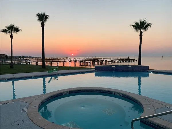 a kitchen with stainless steel appliances a microwave a stove a table and chairs in it